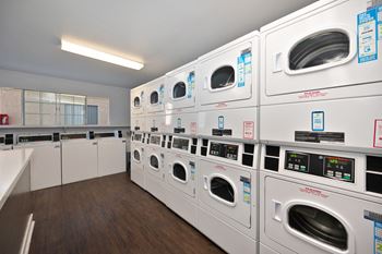 a row of washing machines in a laundry room